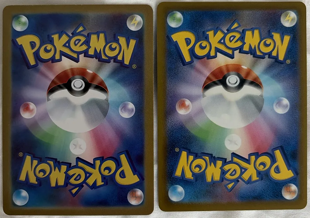 Two Japanese Pokémon card backs side by side: a counterfeit on the left with smooth, lighter colors, and a genuine card on the right with a darker, grainy blue