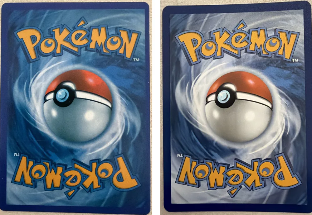 Two English-style Pokémon card backs side by side: a counterfeit on the left in a darker, more saturated blue, and a genuine card on the right in a lighter grey-blue with brighter white swirls